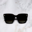 An image of the Breitling Marisol 0005 Square Sunglasses in Havana frame frontal view with arms closed marble background