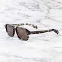 An image of the GR15 Aviator Sunglasses in Grey Havana frame side view with arms open marble background