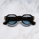 An image of the Palace Cutler and Gross Victory Round Sunglasses in Havana frame frontal view with arms closed marble background