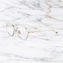 An image of the Pelham 1430 Round Opticals in Silver frame side view with arms open marble background