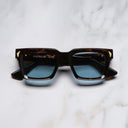 An image of the Palace Cutler and Gross Mercury Square Sunglasses in Havana frame frontal view with arms closed marble background