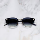 An image of the Breitling Biarritz 0003 Round Sunglasses in Classic Navy Blue frame frontal view with arms closed marble background