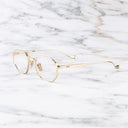 An image of the Lansdowne 1431 Square Opticals in Gold frame side view with arms open marble background