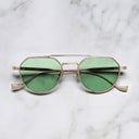 An image of the Draycott 1426 Round Sunglasses in Jewel Gold frame frontal view with arms closed marble background