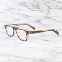 An image of the GR14 Aviator Opticals in Grey on Granny Chic frame side view with arms open marble background
