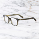 An image of the GR10 Square Opticals in Olive frame side view with arms open marble background