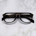 An image of the Cutler and Gross 0822V2 Aviator Horn Optical in Slate Grey Buffalo Horn frame frontal view with arms closed marble background