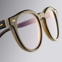 An image of the Cutler and Gross 1378 Round Horn Optical in Smoke Brown/Cream Buffalo Horn frame detail close up of left lens and temple
