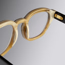 An image of the Cutler and Gross 9290 Round Horn Optical in Smoke Brown/Cream Buffalo Horn frame detail close up from left side view