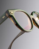An image of the Cutler and Gross 9298 Round Horn Optical in Moss Green/Brown Buffalo Horn frame detail close up of left hinge and temple. This image is titled as Buffalo Horn, fully clickable and linking to all buffalo horn sunglass and optical frames.