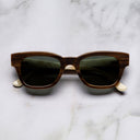An image of the Cutler and Gross 0772 Square Horn Sunglass in Toffee Brown/Cream Buffalo Horn frame frontal view with arms closed marble background