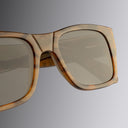 An image of the Cutler and Gross 1214 Rectangular Horn Sunglass in Speckled Brown Buffalo Horn frame detail close up of right lens and temple