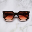 An image of the Cutler and Gross 4469 Square Horn Sunglass in Smoke Brown/Cream Buffalo Horn frame frontal view with arms closed marble background