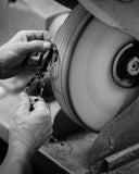 Craft black and white image of a frame being polished in the Italian factory.