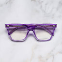 An image of the 1346 Cat Eye Opticals in Orchid Crystal frame frontal view with arms closed marble background