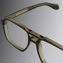An image of the 1394 Aviator Optical in Olive green frame detail close up of left lens and temple, also featuring Cutler and Gross logo in gold placed inside the temple