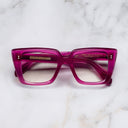 An image of the 1401 Cat Eye Opticals Opal Fuchsia frame frontal view with arms closed Marble background