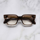 An image of the 1411 Cat Eye Optical in Brown Crystal frame frontal view with arms closed marble background