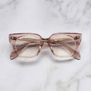 An image of the 1411 Cat Eye Optical in Dusk frame frontal view with arms closed marble background