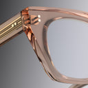 Close-up of a transparent optical frame in blush colour on a gray background, Cutler and Gross, featuring specific to cutler and gross campus pins