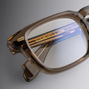 An image of the 1416 Square Optical in Brown Crystal frame detail close up of left lens and temple