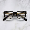 An image of the 1433 Square Optical in Black frame frontal view with arms closed marble background