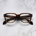 An image of the 1433 Square Optical in Dark Havana frame frontal view with arms closed marble background