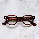An image of the 9290 Round Opticals in Red Havana frame frontal view with arms closed marble background