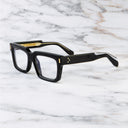 An image of the 9386 Square Optical in Black frame side view with arms open marble background