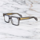 An image of the 9386 Square Optical in Smoke Quartz frame side view with arms open marble background