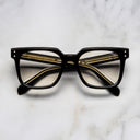 An image of the Cutler and Gross 9387 Square Optical frame in Black frontal view with arms closed in marble background.