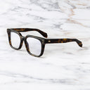 An image of the Cutler and Gross 9387 Square Optical frame in Havana side view with arms open in marble background.