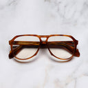 An image of the 9782 Aviator Opticals in Havana Honey Turtle frame frontal view with arms closed marble background