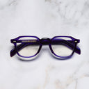 An image of the GR03 Square Optical Glasses in Ink frame frontal view with arms closed marble background