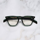 An image of the GR05 Cat Eye Optical Glasses in Striped Dark Green frame frontal view with arms closed marble background