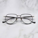 An image of the Pembroke 1429 Aviator Opticals in Black/Gold frame frontal view with arms closed marble background
