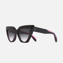 An image of the 1407 Cat Eye Sunglasses Black on Pink frame side view with arms open