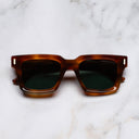 An image of the 1386 Square Sunglasses in Honey Havana frame frontal view with arms closed marble background