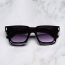An image of the 1386 Square Sunglasses in Purple on Black frame frontal view with arms closed marble background
