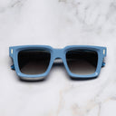 An image of the 1386 Square Sunglasses in Solid Light Blue frame frontal view with arms closed marble background