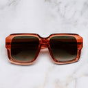 An image of the 1388 Square Sunglasses in Watermelon Crystal frame frontal view with arms closed marble background