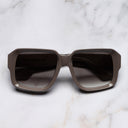 An image of the 1388 Square Sunglasses in Mud frame frontal view with arms closed marble background