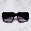 An image of the 1388 Square Sunglasses in Purple on Black frame frontal view with arms closed marble background