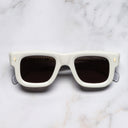 An image of the 1402 Square Sunglasses in White Ivory frame frontal view with arms closed marble background