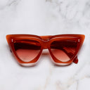 An image of the 1407 Cat Eye Sunglasses in Rouge frame frontal view with arms closed marble background