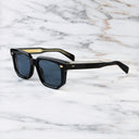 An image of the 1410 Square Polarised Sunglasses in Black frame side view with arms open marble background