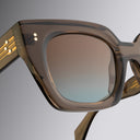 A close up image of Cutler and Gross brown crustal acetate sunglasses with gradient brown lenses from Serpentine SS26 collection.