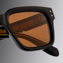 An image of the Cutler and Gross 1434 Square Sunglass frame detail close up of left lens and temple in grey background.