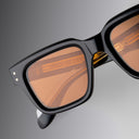 An image of the Cutler and Gross 1434 Square Sunglass frame detail close up from right side view in grey background.
