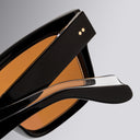 An image of the Cutler and Gross 1434 Square Sunglass frame detail close up of right hinge and temple in grey background.